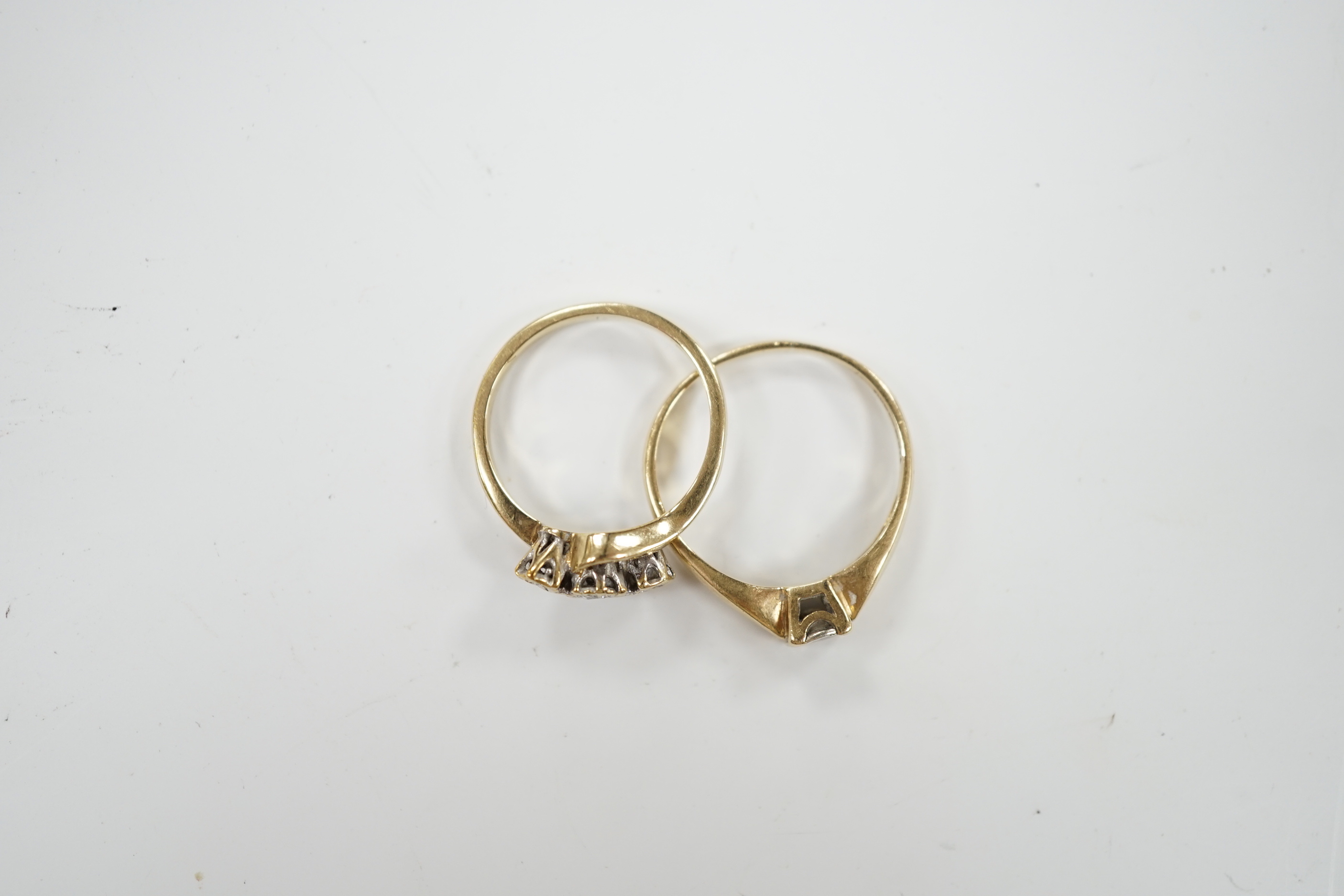 Two 9ct gold and diamond set rings including three stone and solitaire